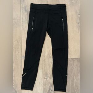 Lululemon black 3/4 leggings with zipper pockets.